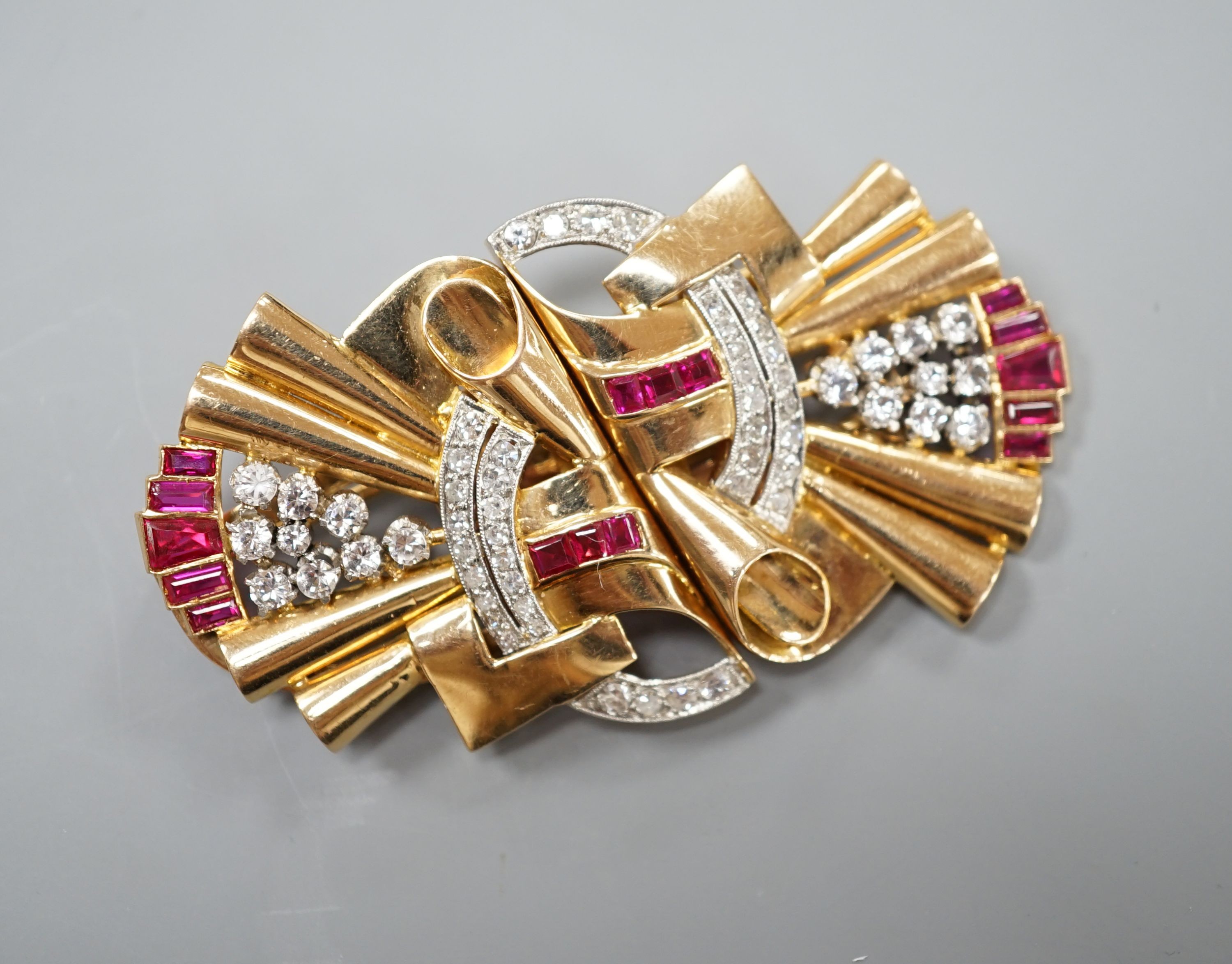 A 1950's yellow metal, white stone, diamond and synthetic? ruby set fan shaped double clip brooch, overall 66mm, gross 39.4 grams